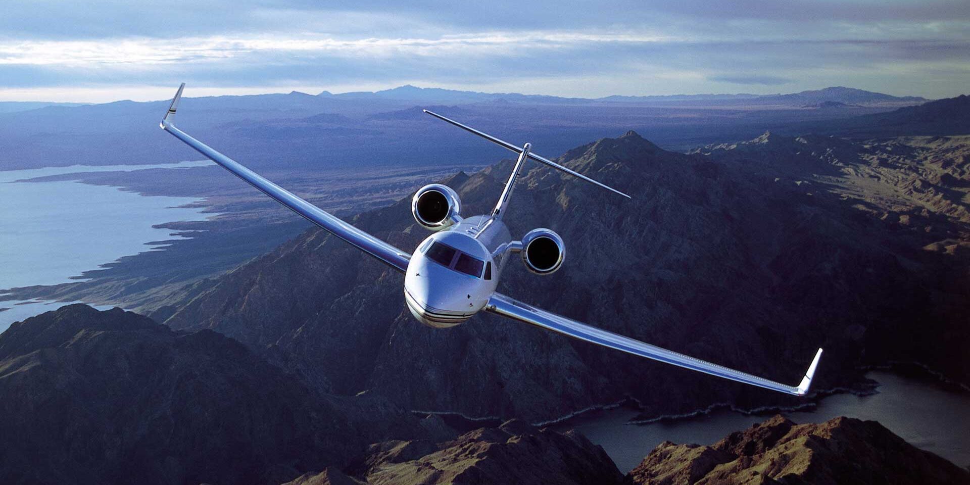 Corporate aircraft flying over mountain