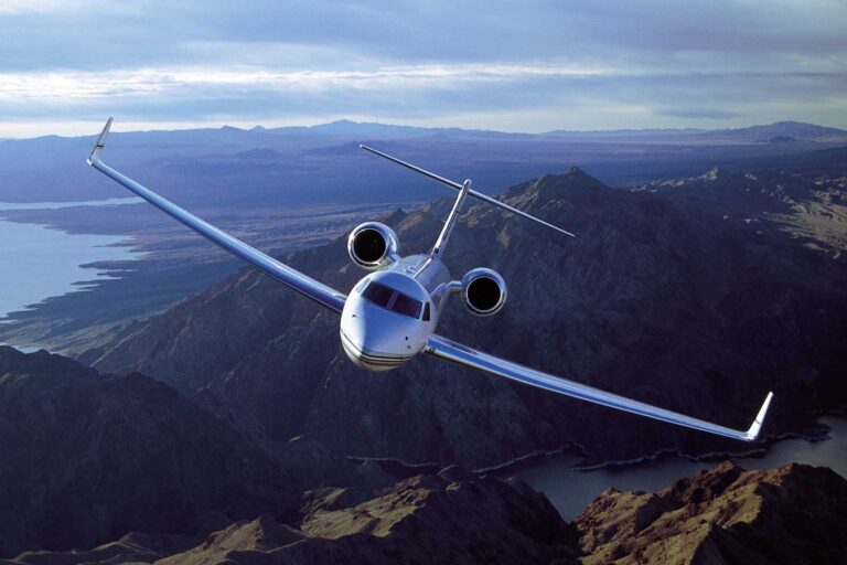Corporate aircraft flying over mountain